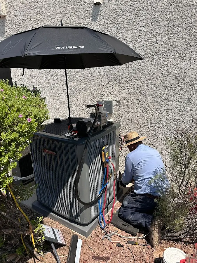 HVAC technician performing outdoor AC maintenance in Sparta